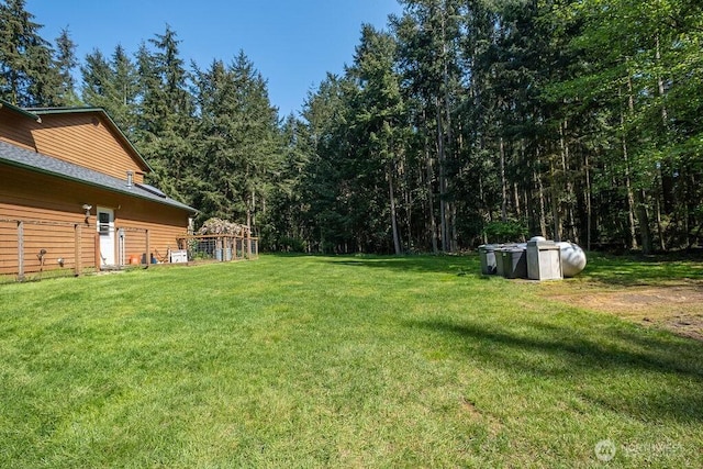 view of yard with a view of trees