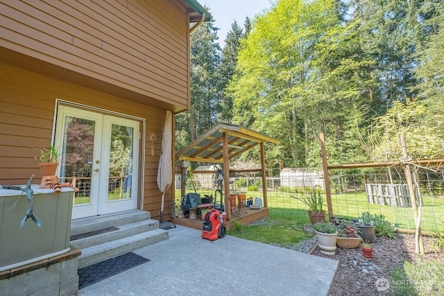 view of patio / terrace featuring french doors and fence