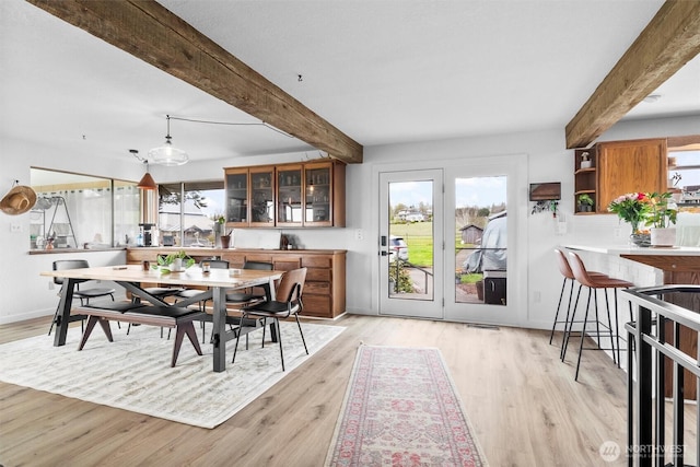 5752 Ronnie Hill Ln, Ferndale, WA 98248 - dining room with a healthy amount of sunlight, beam ceiling, and light wood-type flooring