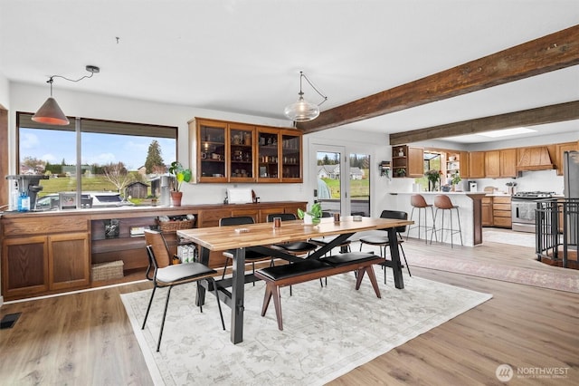 5752 Ronnie Hill Ln, Ferndale, WA 98248 - dining space with visible vents, beam ceiling, and light wood finished floors