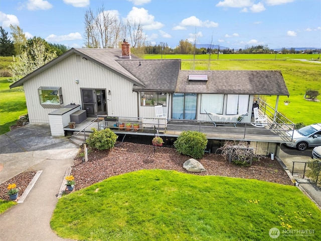 5752 Ronnie Hill Ln, Ferndale, WA 98248 - rear view of property with a chimney, roof with shingles, a yard, and a deck
