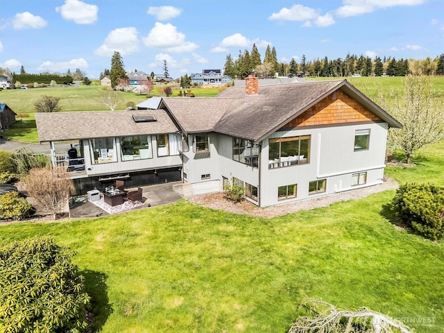 5752 Ronnie Hill Ln, Ferndale, WA 98248 - rear view of house featuring a lawn, a chimney, and roof with shingles