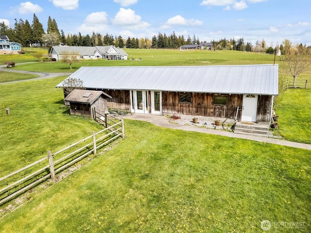 5752 Ronnie Hill Ln, Ferndale, WA 98248 - back of property featuring fence, an outbuilding, a yard, and metal roof