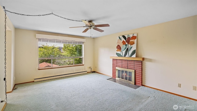 unfurnished living room featuring a ceiling fan, a brick fireplace, carpet floors, a baseboard radiator, and baseboards