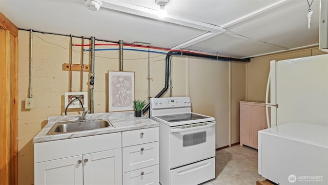 kitchen with a sink, white cabinets, white appliances, and light countertops