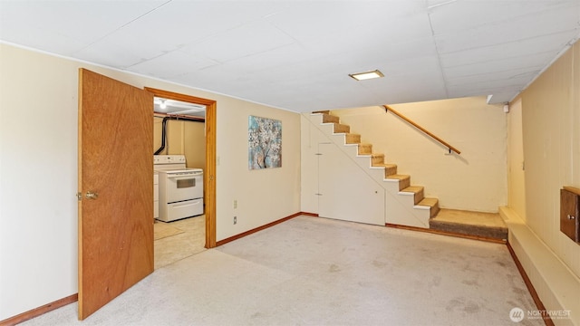 finished basement featuring carpet floors, baseboards, and stairway