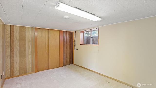 basement with baseboards and carpet