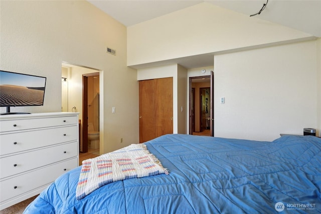 bedroom with visible vents, connected bathroom, and high vaulted ceiling