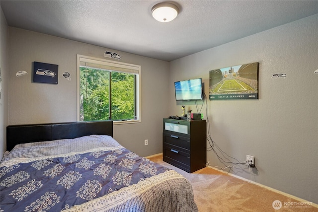 bedroom featuring light carpet