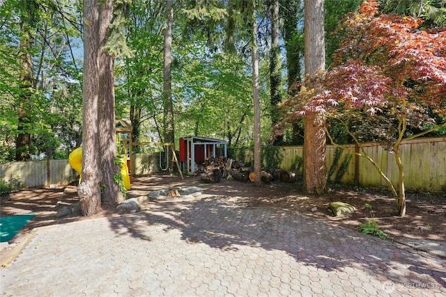 view of yard with a fenced backyard and an outbuilding