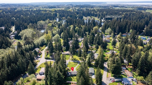 birds eye view of property with a wooded view