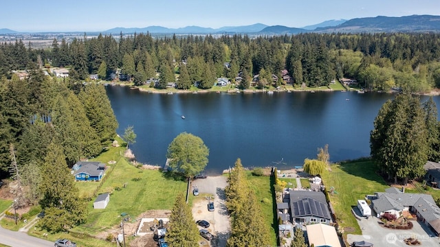 bird's eye view featuring a water and mountain view and a wooded view
