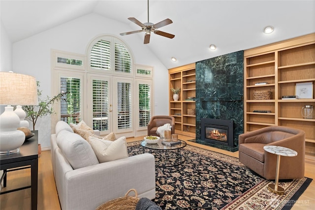 3307 Sahalee Way NE, Sammamish, WA 98074 - living room featuring high vaulted ceiling, wood finished floors, built in shelves, ceiling fan, and a fireplace
