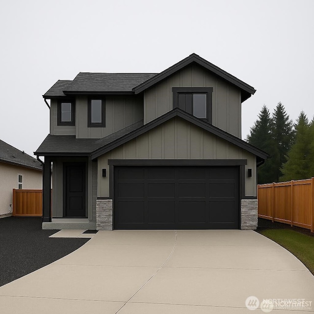 530 Cedar St, Toledo, WA 98591 - view of front of house featuring concrete driveway, stone siding, a garage, roof with shingles, and board and batten siding
