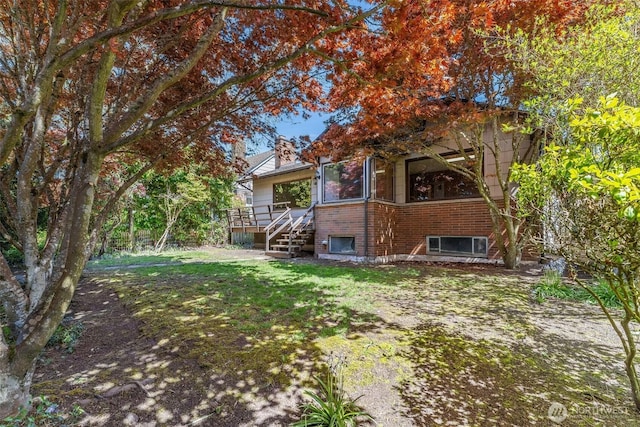 view of yard featuring a deck and stairway