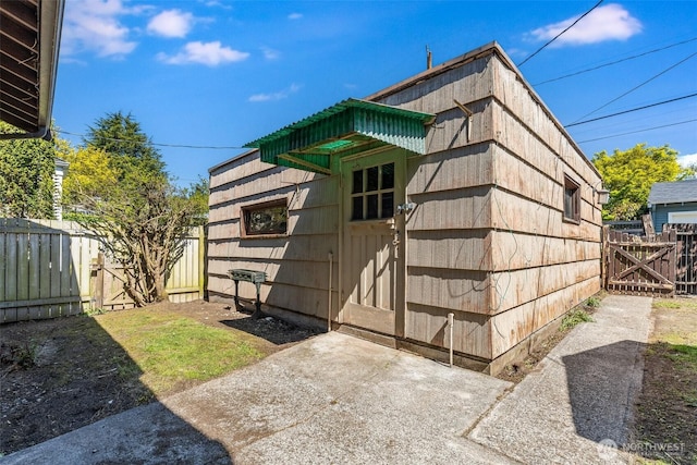 view of outbuilding with fence