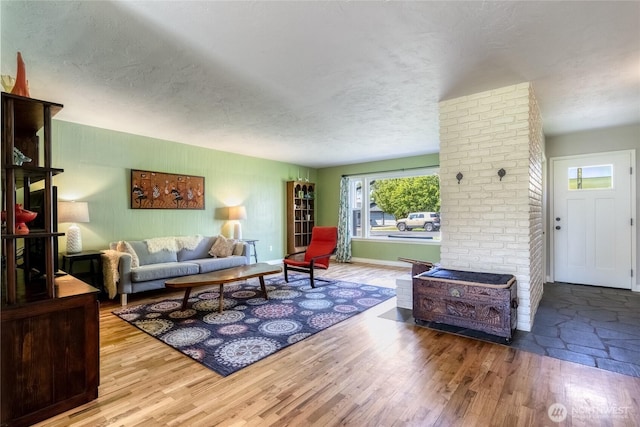 living room with a textured ceiling and wood finished floors