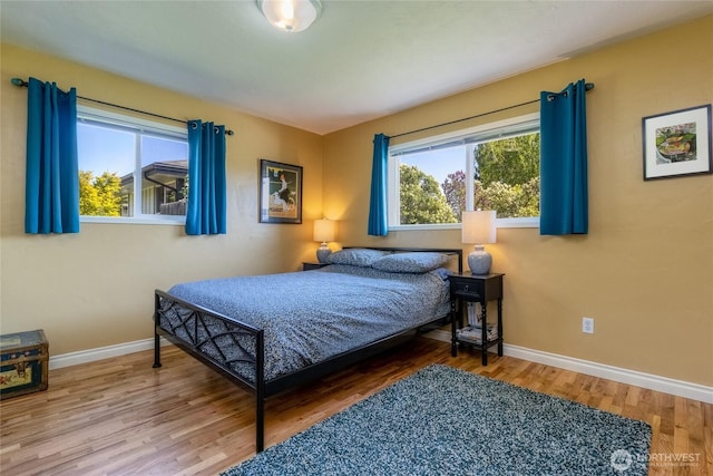 bedroom with wood finished floors and baseboards