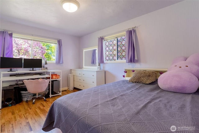 bedroom featuring radiator heating unit and wood finished floors