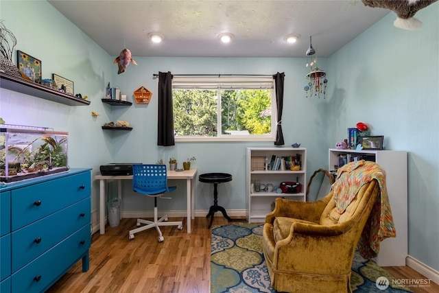 office space with baseboards and wood finished floors