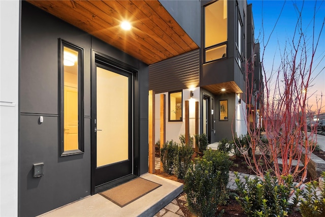 exterior entry at dusk with stucco siding