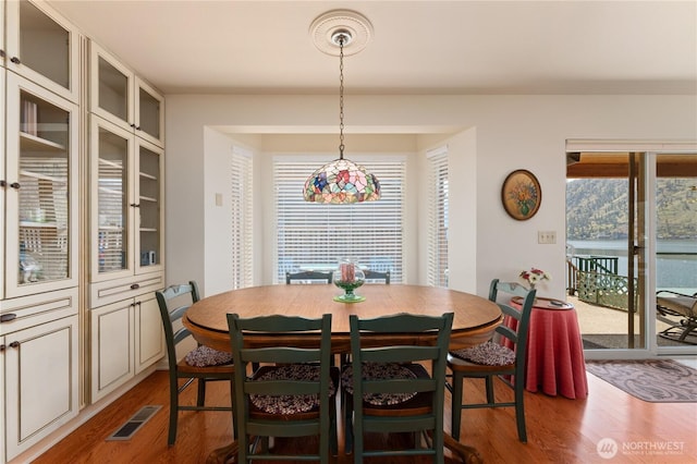 dining room featuring visible vents and wood finished floors