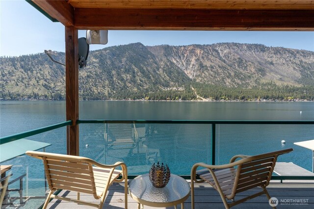 balcony featuring a water and mountain view