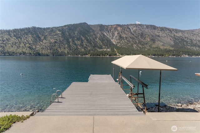 view of dock featuring a water and mountain view