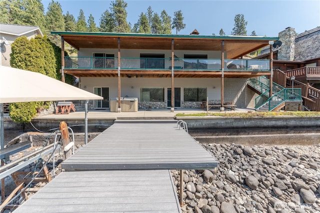 rear view of property with a patio and stairway