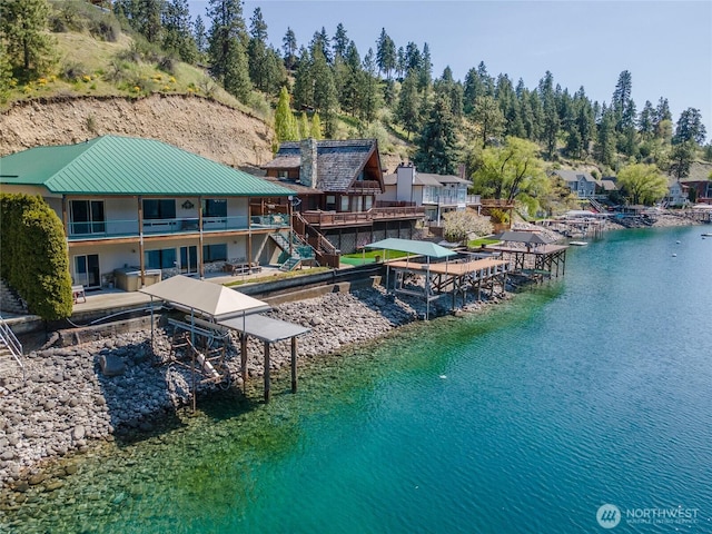 birds eye view of property with a water view