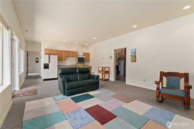 living area with recessed lighting, water heater, light colored carpet, and baseboards