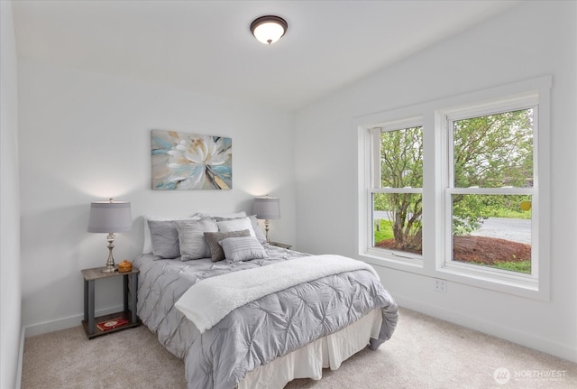 bedroom featuring baseboards and carpet