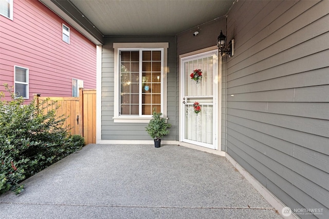 doorway to property with fence