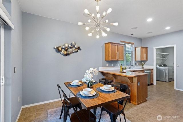 dining space with separate washer and dryer, baseboards, an inviting chandelier, and recessed lighting