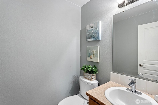bathroom with toilet and vanity