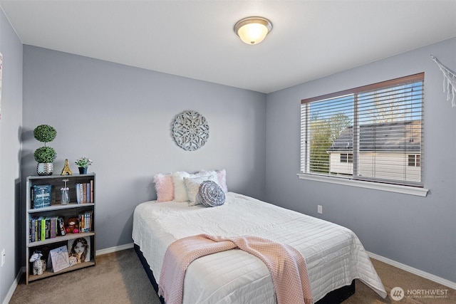 bedroom featuring baseboards and carpet floors