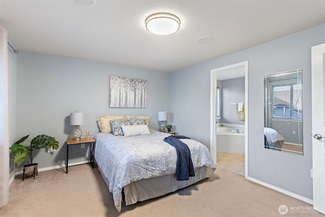 carpeted bedroom featuring baseboards and connected bathroom