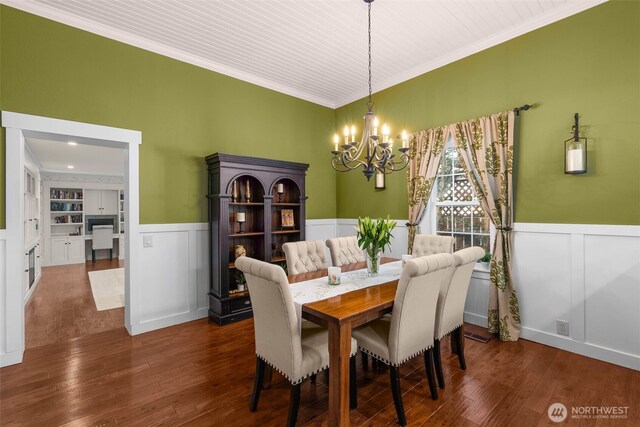 245 SE Bush St, Issaquah, WA 98027 - dining room with a chandelier, wainscoting, a decorative wall, crown molding, and wood finished floors