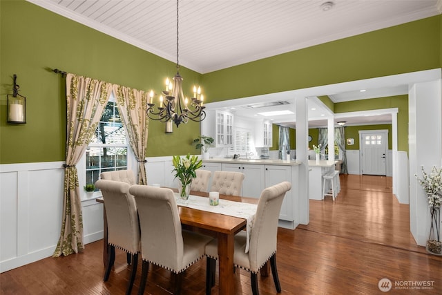 245 SE Bush St, Issaquah, WA 98027 - dining room with a chandelier, ornamental molding, wainscoting, a decorative wall, and dark wood-style floors