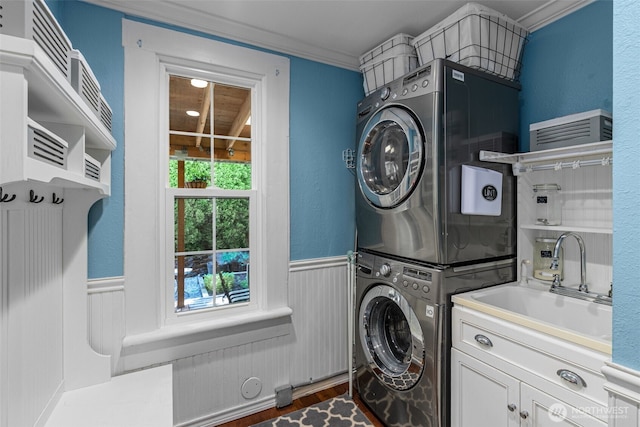 245 SE Bush St, Issaquah, WA 98027 - laundry room with estacked washer and dryer, cabinet space, wainscoting, crown molding, and dark wood-style flooring