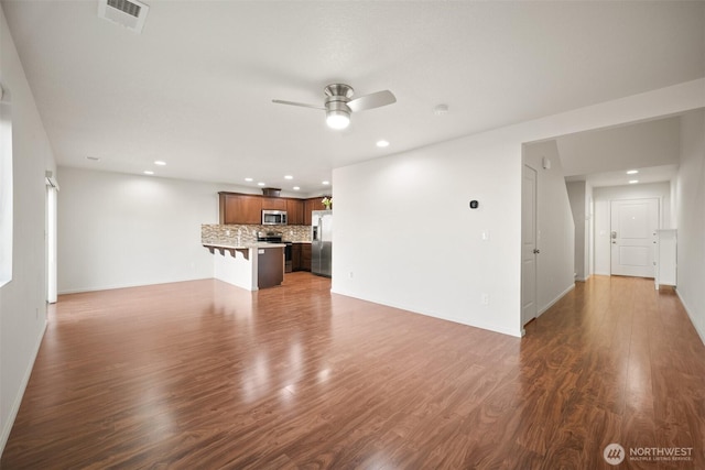 unfurnished living room with recessed lighting, dark wood-style flooring, visible vents, and ceiling fan
