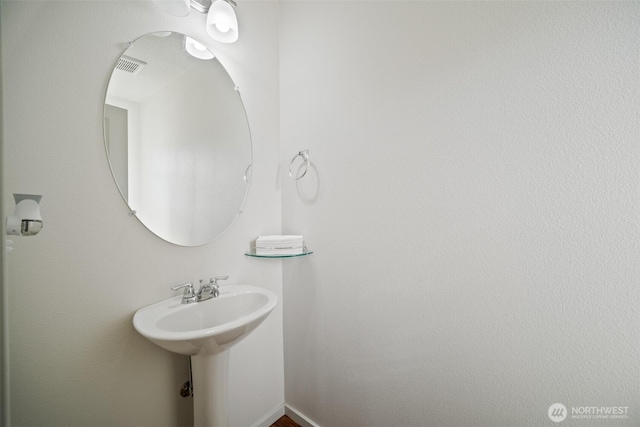 bathroom featuring visible vents and a sink