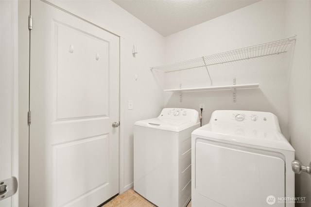 washroom with washing machine and clothes dryer and laundry area