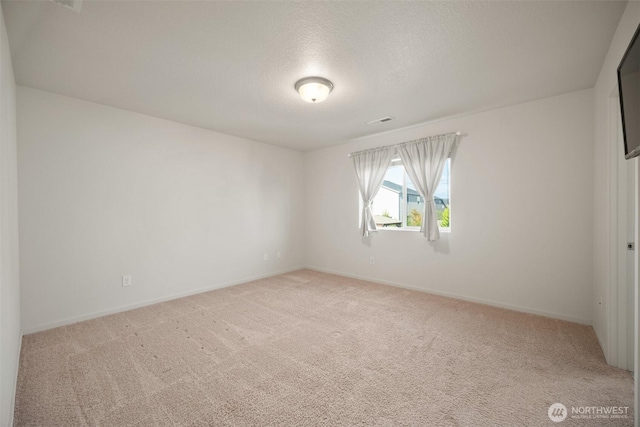 unfurnished room featuring light carpet, visible vents, and baseboards