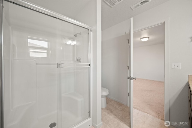 full bathroom with visible vents, toilet, vanity, and a stall shower