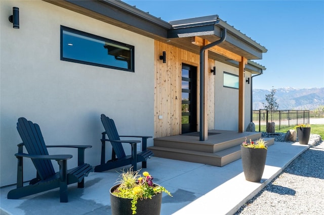 view of patio / terrace with a mountain view and fence