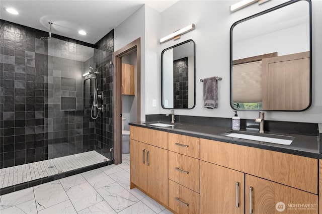 full bath with marble look tile flooring, walk in shower, double vanity, toilet, and recessed lighting