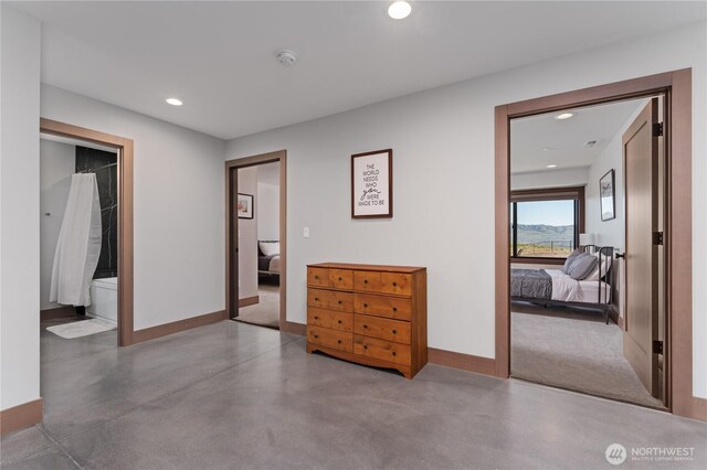 bedroom with baseboards, concrete floors, and recessed lighting