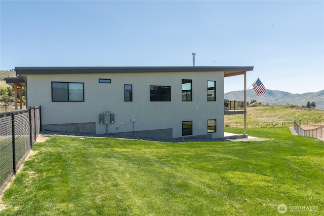 rear view of house featuring a mountain view