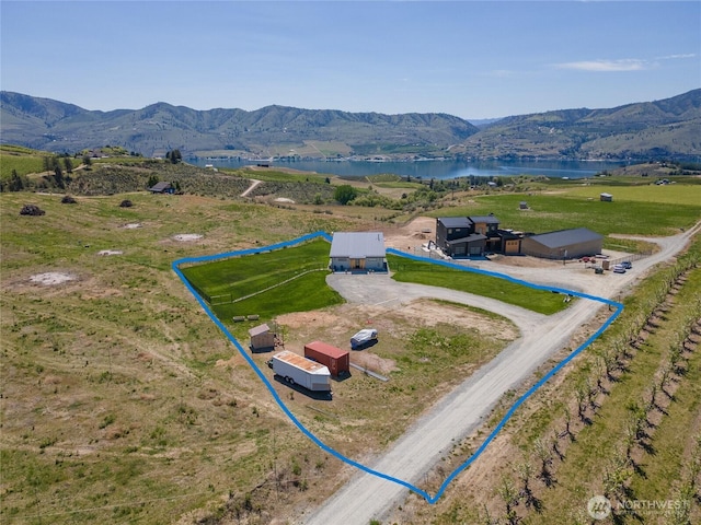 view of property location featuring a water and mountain view and property parcel outlined